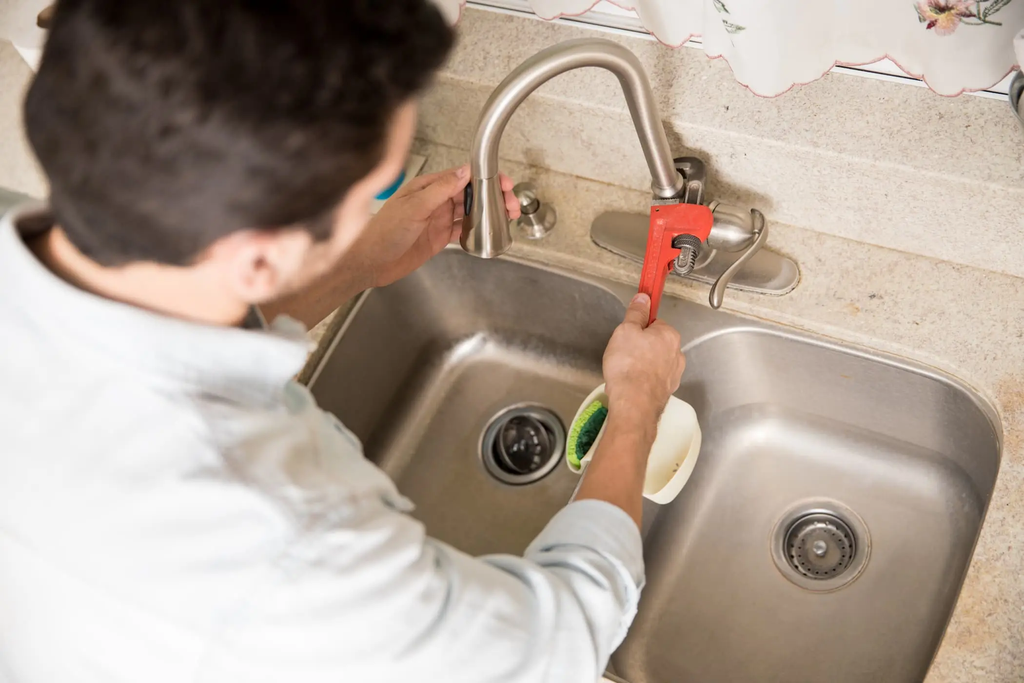 male-plumber-using-wrench-tighten-water-faucet-kitchen-seen-up-close-1